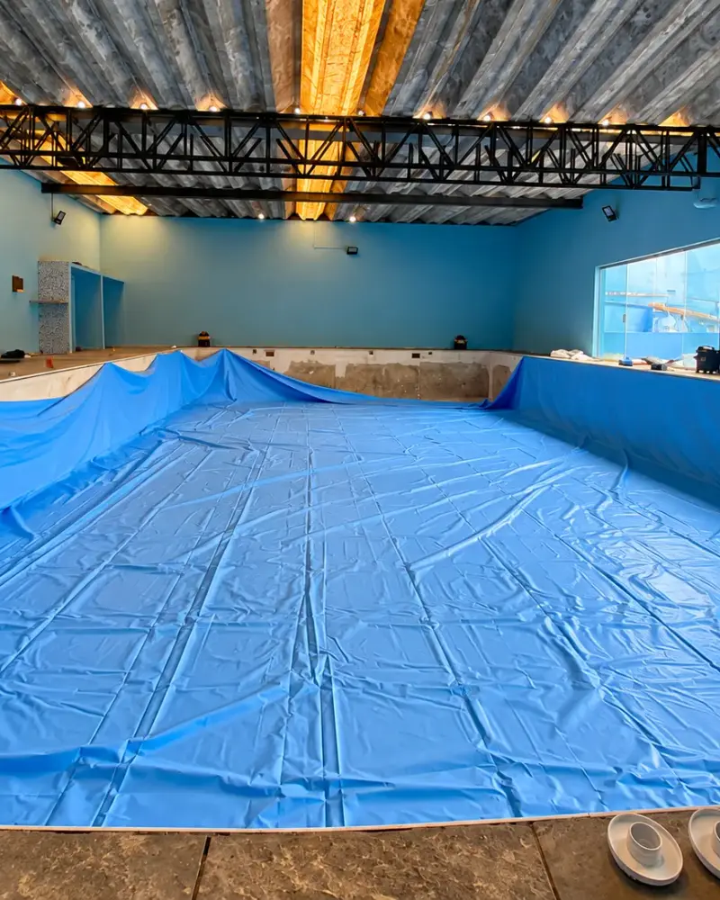 A mesma piscina de academia durante a troca, com o vinil azul novo sendo instalado, em São Bernardo do Campo